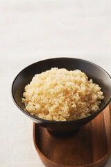 Rice in wooden plate on table top view.