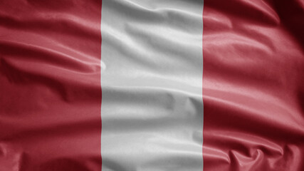 Peruvian flag waving in the wind. Close up of Peru banner blowing soft silk.