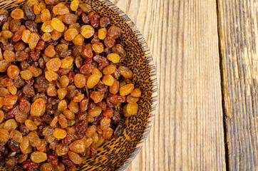Dried grapes, raisins in wooden bowl. Studio Photo