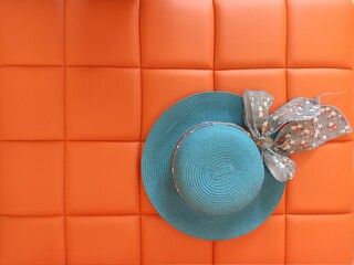 Hat on an orange background. Summer. The sun