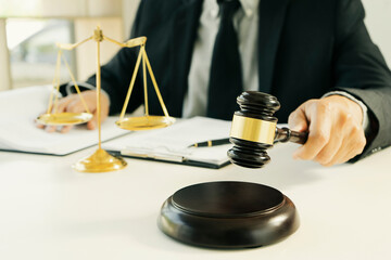 The judge is hammering down the gavel as a sign of the verdict