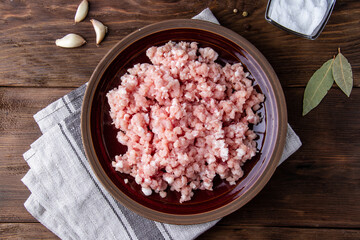 Minced light meat on a plate on a wooden table