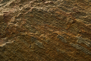 The surface of the large rocks along the beach. Dark brown and gray stones surface texture background. grunge background.
