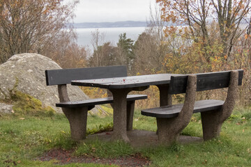 Stone benches on the shores of Lake Vettern, cloudy autumn day.