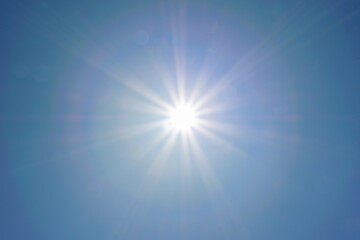 Clear blue sky, sun, beautiful sunbeams and glare
