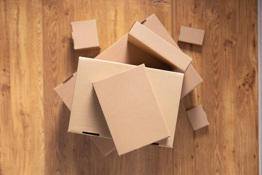 Stack of cardboard box on floor laminate background. Empty box case top view