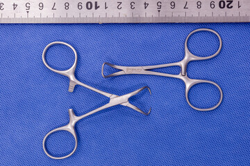 Backhouse towel forceps on a blue background