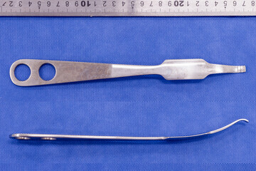 hohmann retractor on a blue background