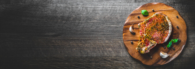 Raw Pork Loin chops marinated meat Steak for bbq on wooden table background