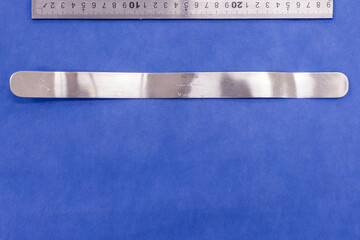 Malleable retractor on a blue background