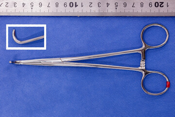 mixter right-angled tissue forceps on a blue background