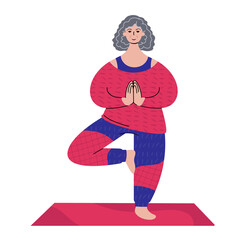 Practicing yoga. Senior caucasian woman standing in a tree pose.