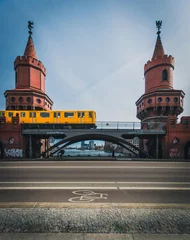 Papier Peint photo Berlin The Oberbaum Bridge, German Oberbaumbrucke and River Spree in Berlin, Germany. U-bahn going over the bridge