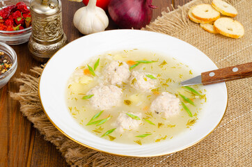 White plate of meatball soup. Studio Photo
