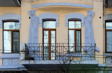 Facade of an old historic building with statues in Kyiv, Ukraine