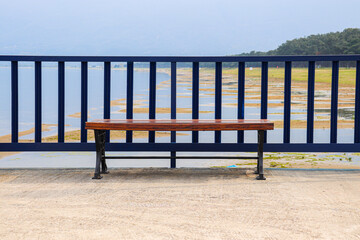 Fototapeta na wymiar Lonely Bench in the Lake