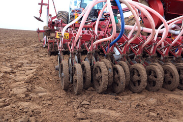 Part of the sowing agricultural machinery in the spring field during the sowing of spring crops, close-up
