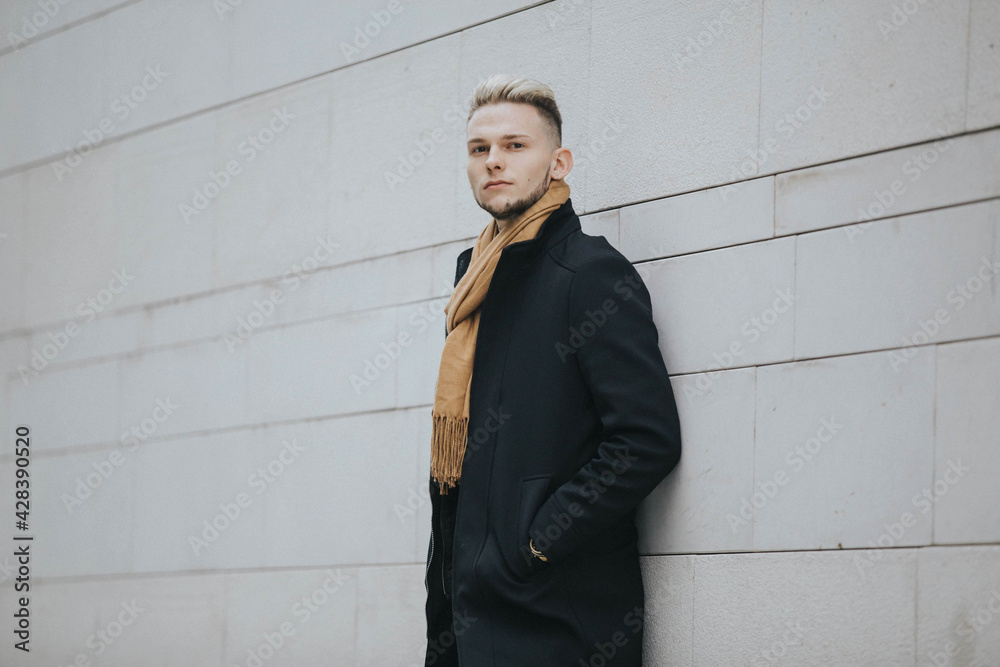 Poster caucasian stylish male posing outdoors in a snowy city