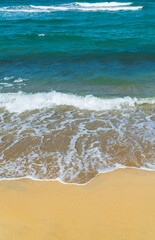 Fototapeta na wymiar waves on the sand beach vertical 