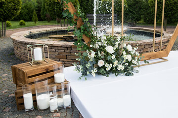Close up of wedding ceremony with arch in rustic style with fresh flowers