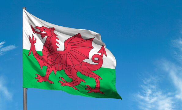 Flag of Wales with red dragon waving against blue sky, Cardiff