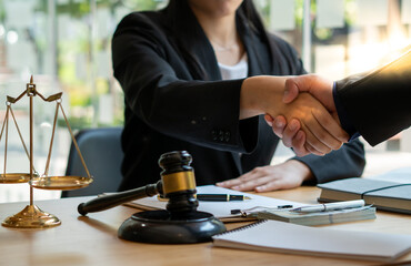 Businessman shaking hands to seal a deal with his partner lawyers or attorneys discussing a contract agreement.Legal law, advice, and justice concept.