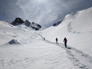 Hiking on skis on the great swiss mountains. Fantastic view in winter time. Ski touring couple. Ski touring track