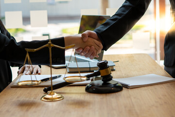 Businessman shaking hands to seal a deal with his partner lawyers or attorneys discussing a contract agreement.Legal law, advice, and justice concept.