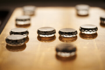 glass pieces of chinese chess on the gold colored chess board