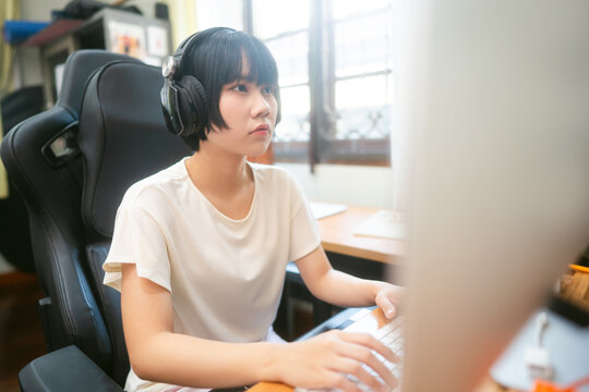 Young adult asian woman stay at home using computer for internet online.