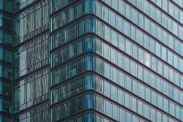 Fototapeta na wymiar Glass window wall background of a modern city high-rise building