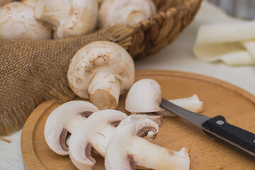 Sliced ​​champignons close-up on a wooden board. Cooking vegetarian food.