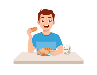 young good looking man eat bread and drink milk