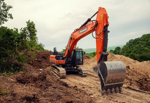 Bulgaria, Radanovo, MAY 20th, 2020: One orange chain excavators clearing the terrain during the construction of South Stream pipeline 