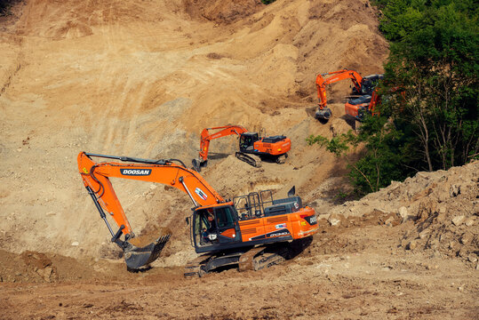 Bulgaria, Radanovo, MAY 19th, 20202: Three orange chain excavators digging on a slope during the construction of South Stream pipeline 