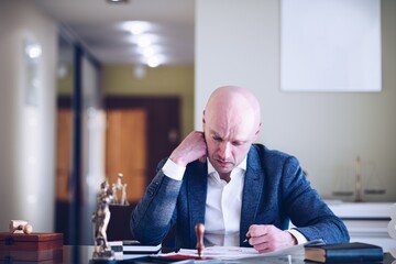 A busy lawyer, businessman, notary public writes a lawsuit, will or other document.