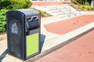 Recycling bin along a pedestrian street on a sunny autumn day
