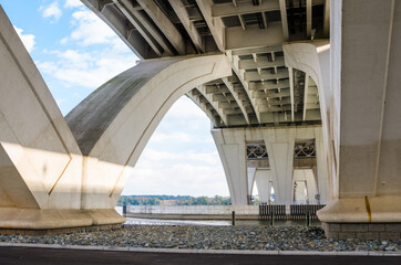 Obraz premium View from below of the pillars and the structure of a highway bridge spannig a river