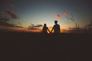 Fototapeta na wymiar romantic couple walking at sunset