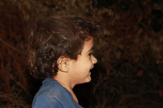 Closeup Profile View Of Smiling Little Boy Child Face. Concept To Low Key Photography