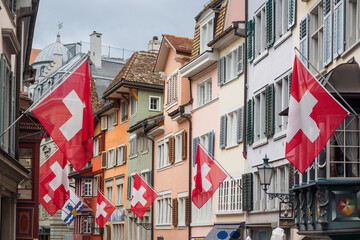 Swiss on the flag on residential buildings in the old town in Zurich, Switzerland