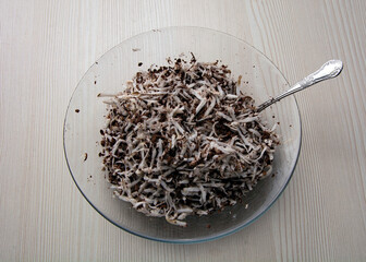 Coconut chips with chocolate on a transparent plate.
