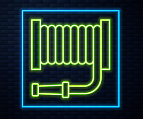 Glowing neon line Fire hose reel icon isolated on brick wall background. Vector