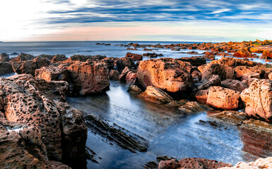 Sea and rocks in sunset