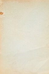 Vertical vintage yellowed paper background texture with stain