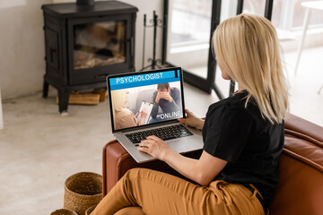 Young woman is using laptop for remote conversation with friend. People having fun staying at home