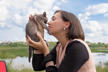 .The pet owner girl is playing with her cat