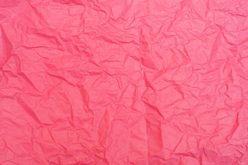 Crumpled pink background. Pink paper, texture and backgrounds.