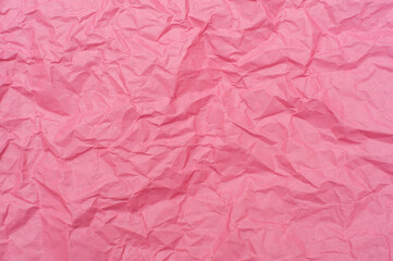 Crumpled pink background. Pink paper, texture and backgrounds.