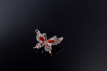 Bijouterie and jewelry on a dark background. Brooches and hairpins earrings and pendants.